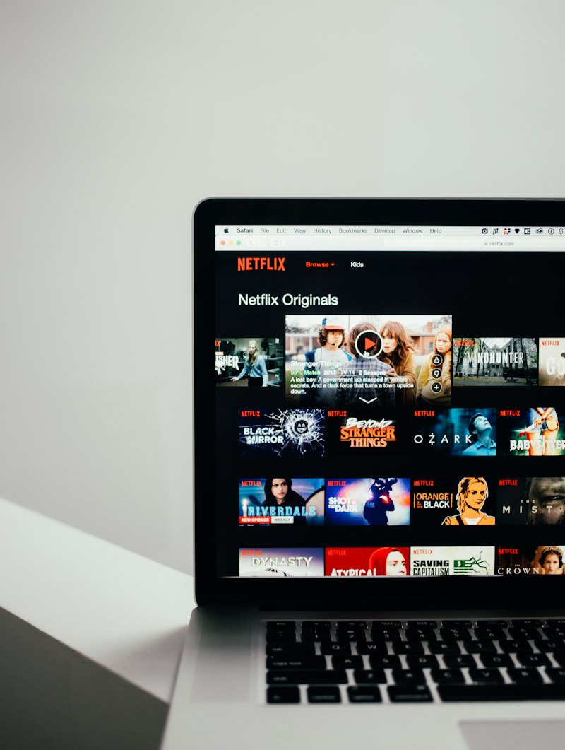 A laptop screen showing a streaming service browse page, the kind of movie night screen that is hard to keep in sync across two different devices