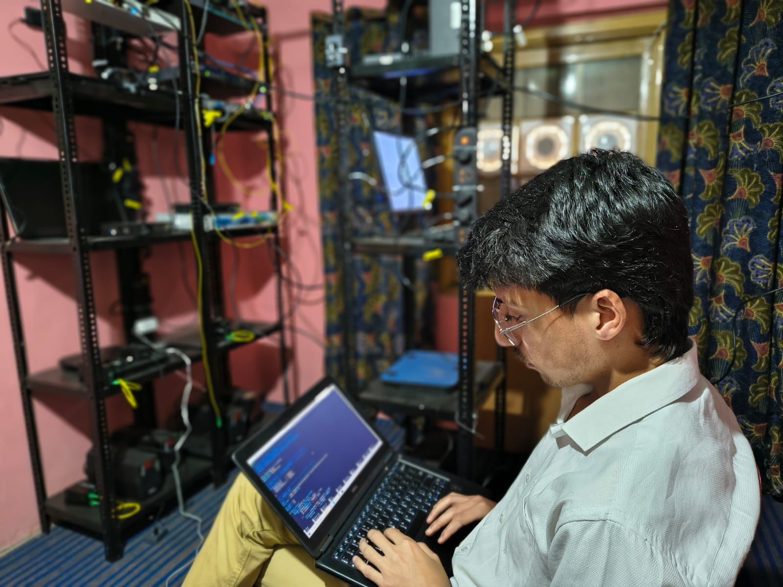 Mehran working in the ViberNet NOC, surrounded by rack-mounted hardware